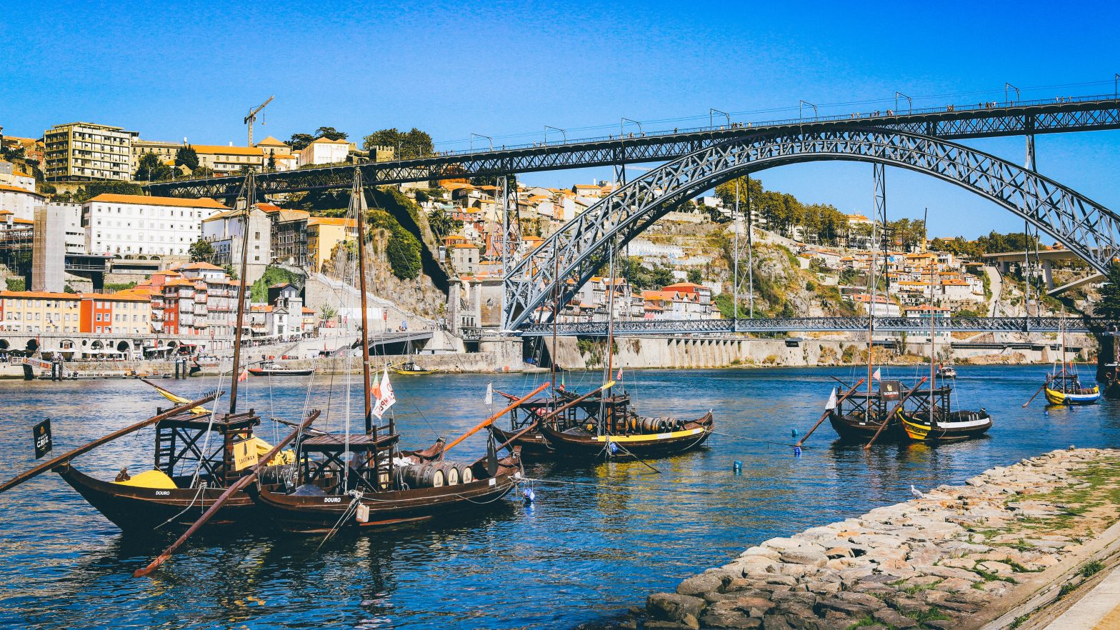 Porto background of river and boats with WCEU 2020 Porto in text