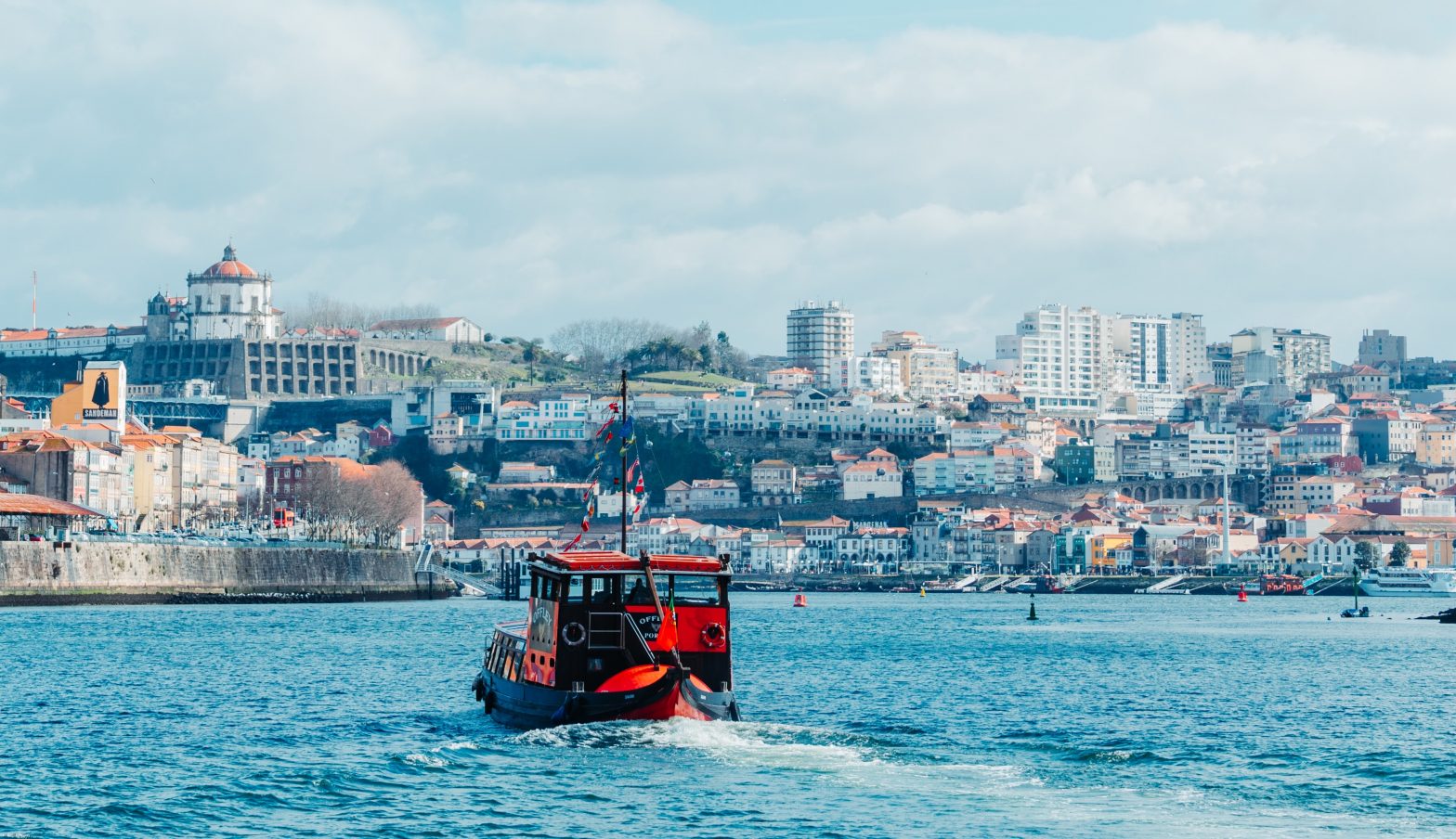 Red boat sailing in the Douro river, northern Portugal